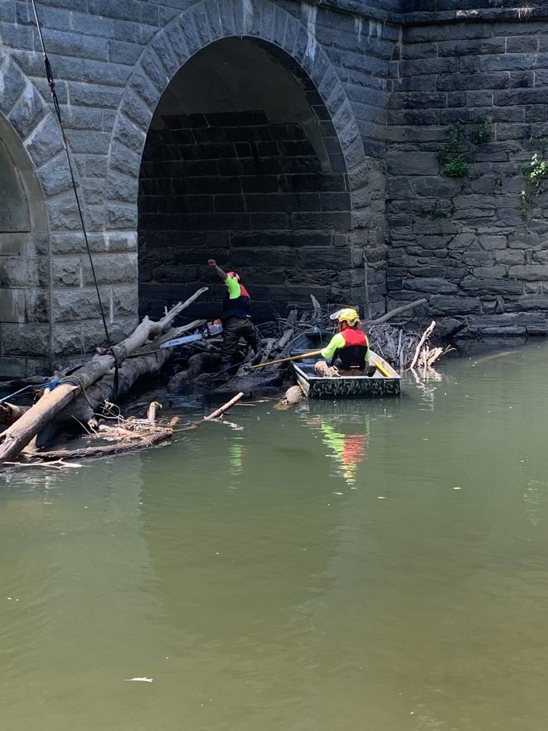 RTEC crew in the boat moving debris.